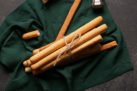 Bunch of tasty Italian Grissini on dark background
