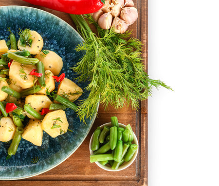 Plate of tasty Potato Salad with vegetables on white backgroundの写真素材