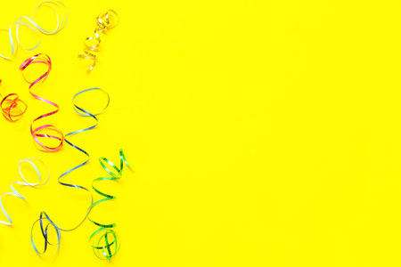 Colorful confetti on yellow background