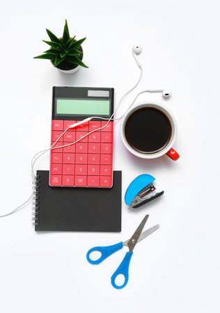 Composition with calculator, coffee, plant and scissors on white backgroundの写真素材