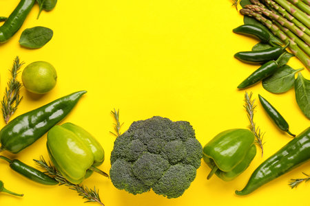 Frame made of different fresh vegetables on yellow backgroundの写真素材