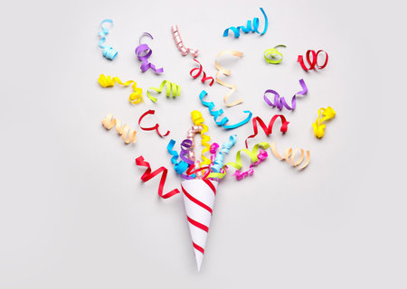 Party cone with serpentine on light backgroundの写真素材