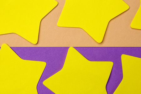 Yellow sticky notes on color backgroundの写真素材