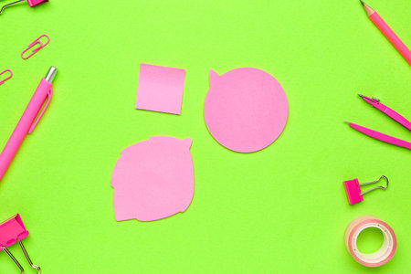 Sticky notes and stationery on green backgroundの写真素材