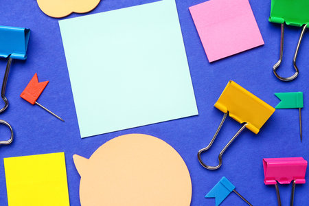Colorful sticky notes and stationery on blue backgroundの写真素材