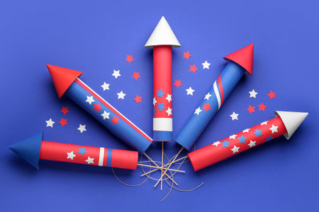 Firework rockets with stars for Independence Day on blue backgroundの写真素材