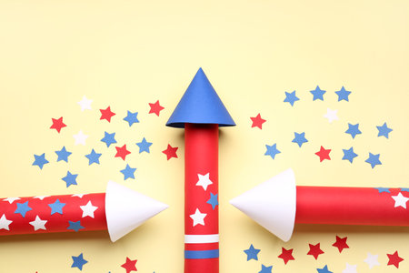 Firework rockets with stars for Independence Day on beige backgroundの写真素材