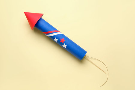 Firework rocket for Independence Day on beige background