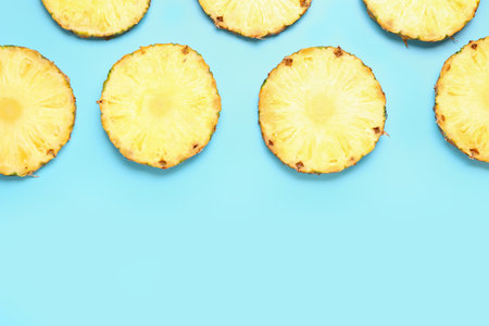 Slices of fresh ripe pineapple on blue backgroundの写真素材