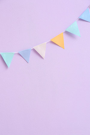 Colorful flags for Festa Junina on lilac backgroundの写真素材