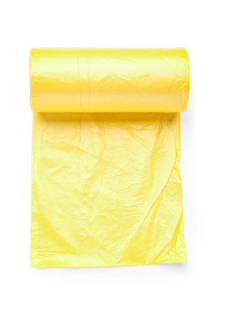 Yellow roll of garbage bags isolated on white backgroundの写真素材