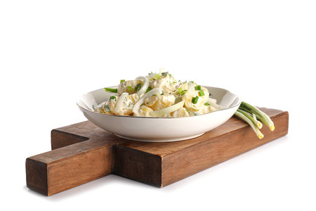 Plate of tasty Potato Salad with greens on white backgroundの写真素材