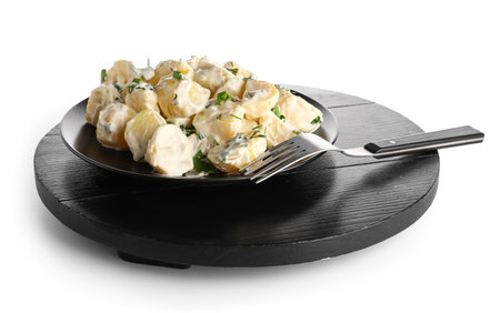 Plate of tasty Potato Salad with greens on white backgroundの写真素材