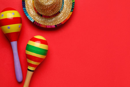Mexican maracas with sombrero hat on red backgroundの写真素材