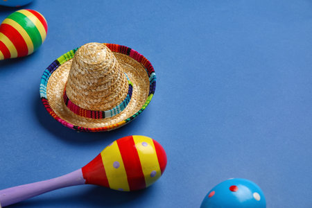 Mexican maracas with sombrero hat on blue background, closeupの写真素材
