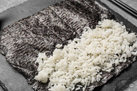 Slate board of nori with rice on table, closeupの写真素材