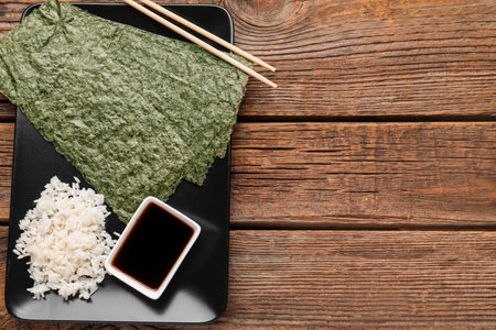 Plate of nori sheets, rice and sauce on wooden backgroundの写真素材