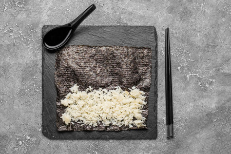 Slate board of nori with rice and sauce on grunge backgroundの写真素材