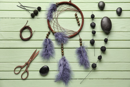 Dream catcher with materials on green wooden backgroundの写真素材