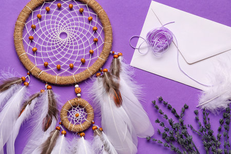 Dream catcher with envelope and lavender flowers on purple backgroundの写真素材