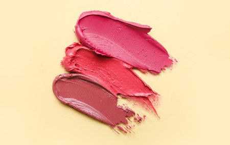 Lipstick strokes on beige background