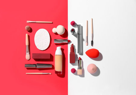 Decorative cosmetics with makeup brushes and sponges on color backgroundの写真素材