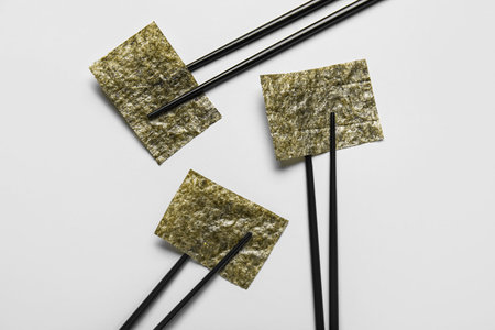 Chopsticks with nori sheets on white backgroundの写真素材