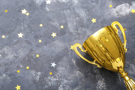 Gold cup with stars on dark background, closeupの写真素材