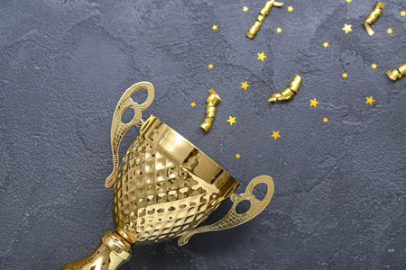 Gold cup with serpentine and stars on dark background, closeupの写真素材