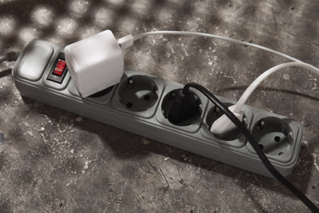 Electric extension cord with plugs on gray grunge backgroundの写真素材