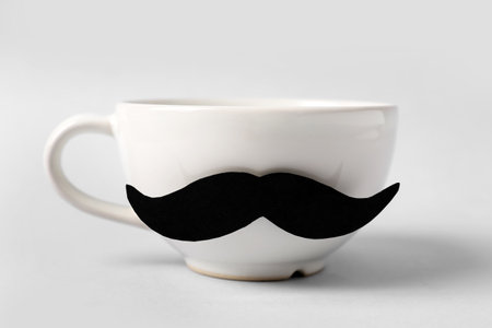 Cup with paper mustache on gray backgroundの写真素材