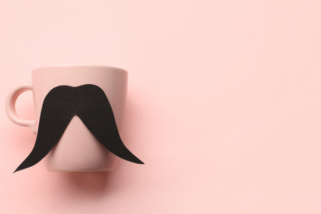 Cup with paper mustache on pink backgroundの写真素材