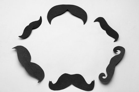 Frame made of black paper mustaches on gray backgroundの写真素材