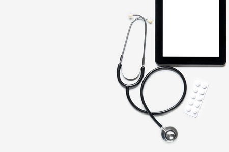 Stethoscope, tablet computer and pills on white backgroundの写真素材