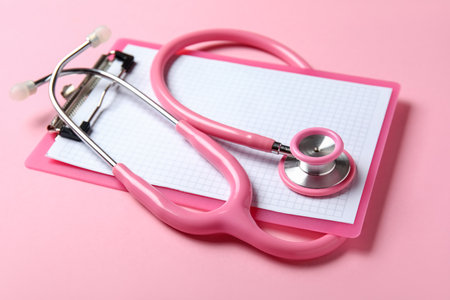 Stethoscope and clipboard on pink backgroundの写真素材