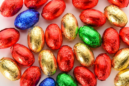 Chocolate Easter eggs in colorful foil isolated on white background