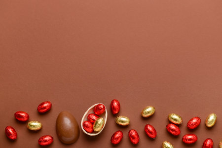 Chocolate Easter eggs and candies on brown backgroundの写真素材