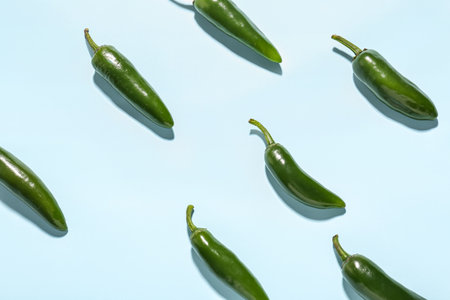 Composition with green pepper on blue backgroundの写真素材