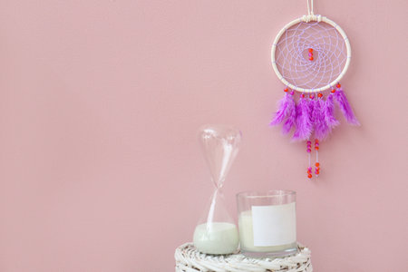 dream catcher hanging on pink wallの写真素材