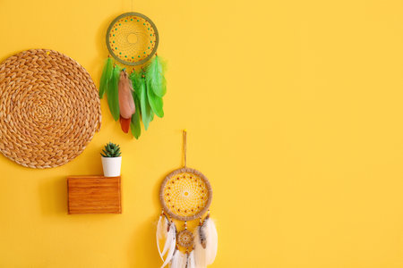 Dream catchers hanging on yellow wall in the bedroom
