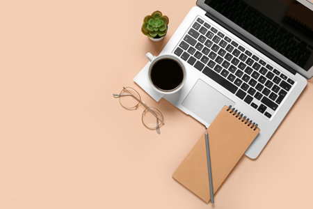 Composition with laptop, coffee and notepad on gray background