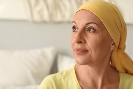 Mature woman after chemotherapy in bedroom, closeupの写真素材