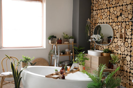 Interior of bathroom with green houseplants, sink and mirrorの写真素材