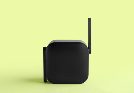 Black WiFi repeater on green backgroundの写真素材