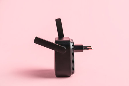 Black WiFi repeater on pink backgroundの写真素材