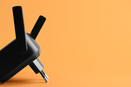 Black WiFi repeater on orange backgroundの写真素材