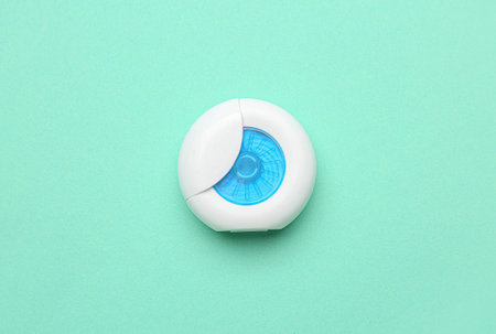 Case with dental floss on turquoise background