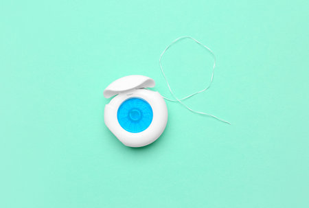 Case with dental floss on turquoise backgroundの写真素材