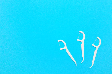 Floss toothpicks on blue backgroundの写真素材