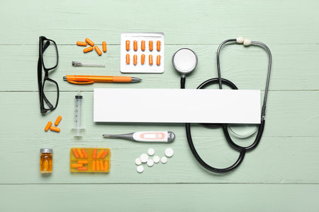 Composition with blank sheet of paper, stethoscope, eyeglasses and medicines on color wooden background. melanoma conceptの写真素材